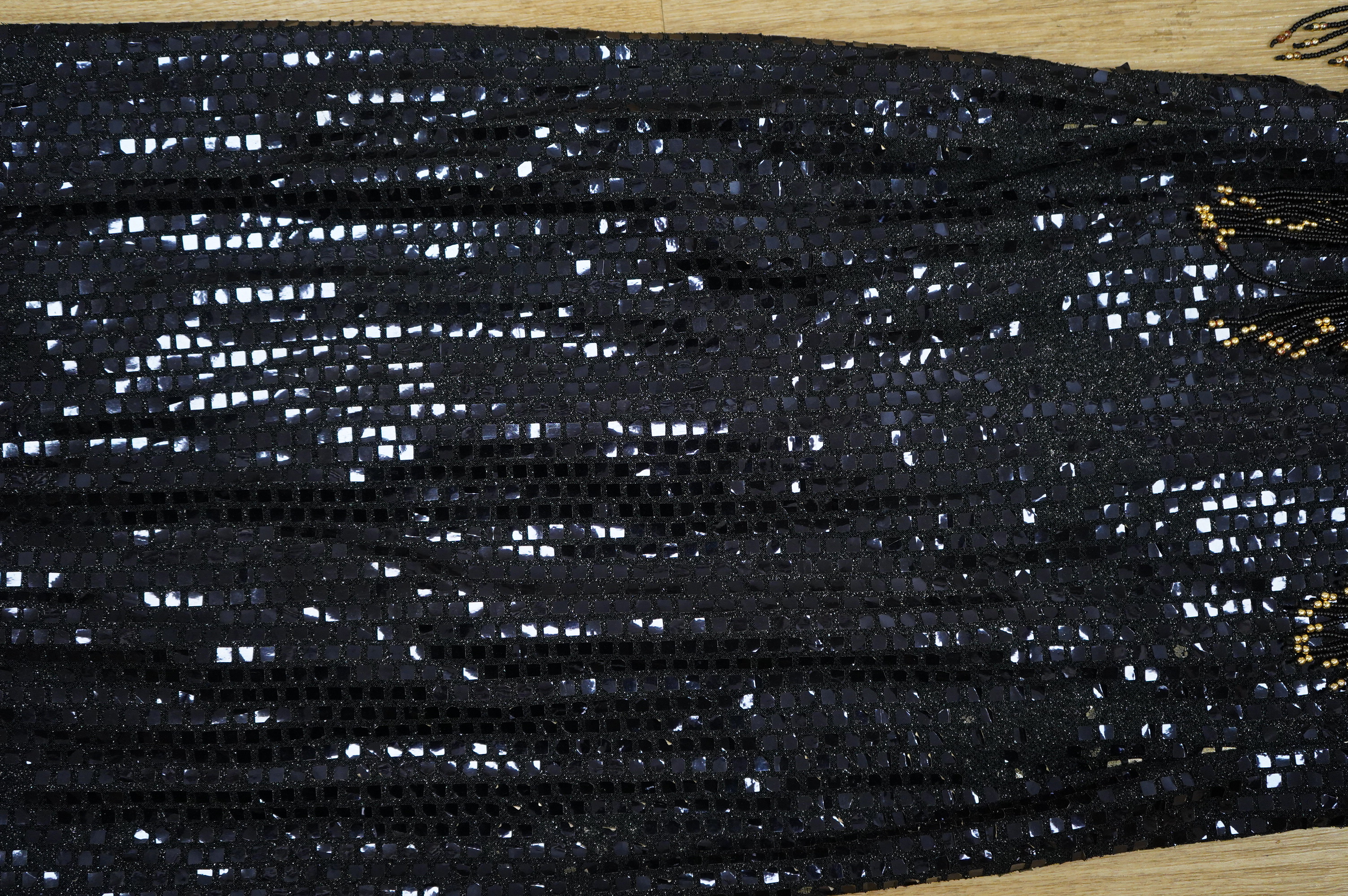 A late 20th century black sequinned, beaded and fringed evening dress, bust 36cm wide at front, together with a lilac chiffon, net, lace and sequin top and matching net evening skirt. Both outfits are a small size